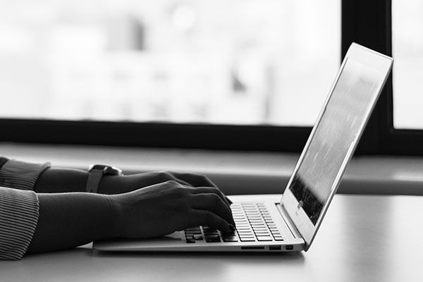 Man Typing on Laptop IT Services and Computer Networking for Medical